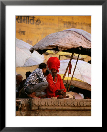 Pilgrim In Discussion With Holy Man, Varanasi, Uttar Pradesh, India by Greg Elms Pricing Limited Edition Print image