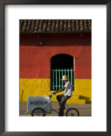 Ice Cream Vendor Riding Bicycle Past Colourful House, Granada, Nicaragua by Margie Politzer Pricing Limited Edition Print image