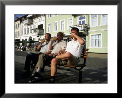 Beer Drinkers Sitting On A Bench, Sonderborg, Denmark by Holger Leue Pricing Limited Edition Print image
