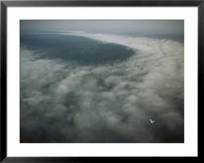 Small Plane Dwarfed By An Immense Cloud Formation by Michael Nichols Pricing Limited Edition Print image