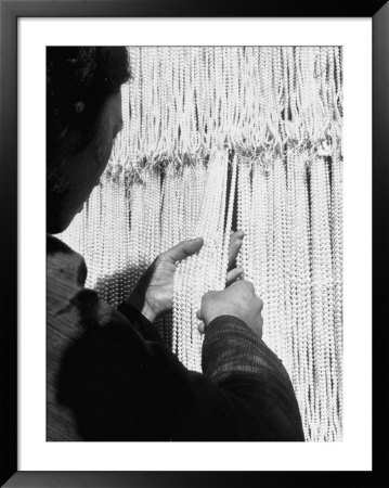 Worker Examining Strands Of Pearls At Factory by Alfred Eisenstaedt Pricing Limited Edition Print image