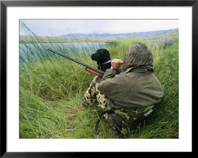 A Hunter Using A Goose Call By A Small Pond In Wyoming by Gordon Wiltsie Pricing Limited Edition Print image