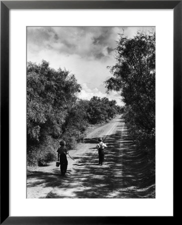 Two Children Walking Down A Dirt Road Going Fishing On A Summer Day by John Dominis Pricing Limited Edition Print image