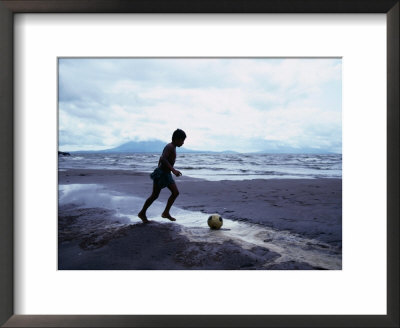 Boy Kicking Soccer Ball On Beach, Lake Nicaragua, Granada, Nicaragua by Eric Wheater Pricing Limited Edition Print image