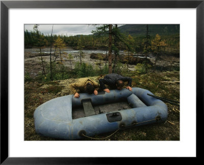 Two Men Use Lung Power To Top Off Their Inflatable Raft by Randy Olson Pricing Limited Edition Print image