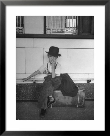 Little Boy Sitting On His Luggage While Waiting For The Train At The Denver Union Station by Sam Shere Pricing Limited Edition Print image