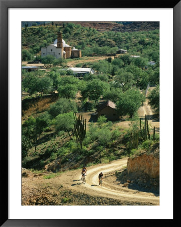 Mountain Bikers Ride Out From Batopillas, Satevo Mission Behind by Skip Brown Pricing Limited Edition Print image