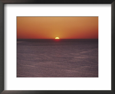 A Brillant Orange Sun Dips Behind The Mediterranean Sea by James L. Stanfield Pricing Limited Edition Print image