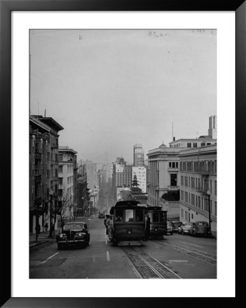 People Riding On Dual Cable Cars, With Bay Bridge Sitting In Background by Charles E. Steinheimer Pricing Limited Edition Print image