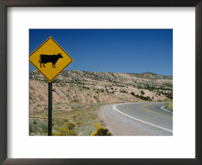 A Stretch Of Road In New Mexico With A Yellow Cattle Crossing Sign by Todd Gipstein Pricing Limited Edition Print image
