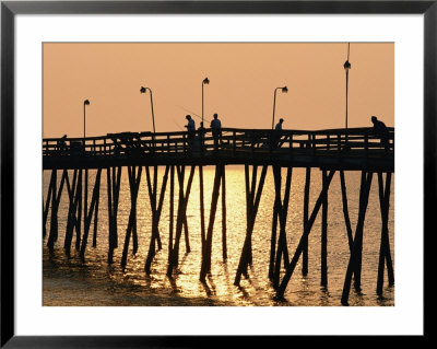 People On A Pier Are Silhouetted At Twilight by Steve Winter Pricing Limited Edition Print image