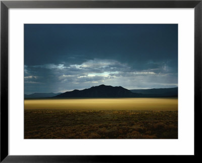 The Setting Sun Permeates Rain Clouds To Brighten Black Rock Desert, Nevada by James P. Blair Pricing Limited Edition Print image