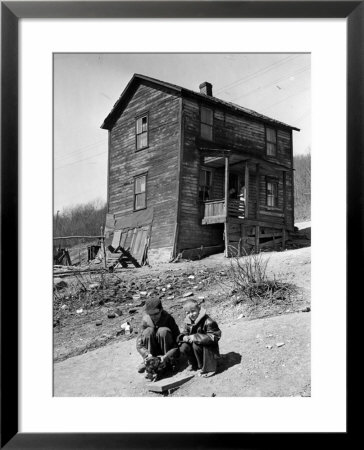 Coal Miner's Boys Playing With Puppy Outside Ramshackle, Two Story House In Dreary Mining Town by Alfred Eisenstaedt Pricing Limited Edition Print image
