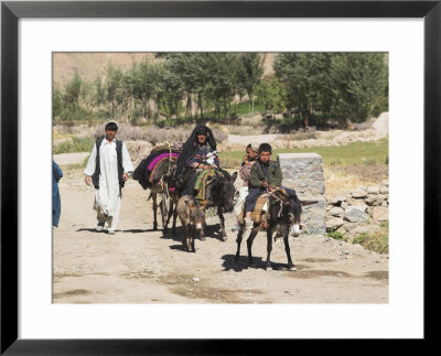 Aimaq People Walking And Riding Donkeys Entering Village, Between Chakhcharan And Jam, Afghanistan by Jane Sweeney Pricing Limited Edition Print image