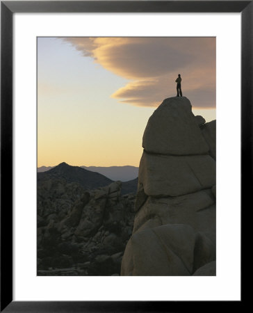 A Climber Watches The Sunset From High Atop A Rock Formation by Jimmy Chin Pricing Limited Edition Print image