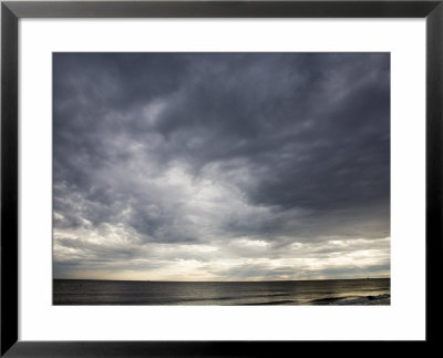 Sun Streams Through Gathering Storm Clouds On North Carolina Coast by David Evans Pricing Limited Edition Print image