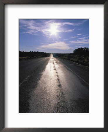 The Sun Reflects On This Black Tarred Road In Arizona by Stephen Alvarez Pricing Limited Edition Print image