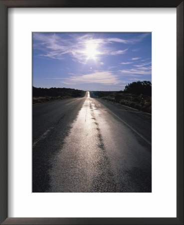 The Sun Reflects On This Black Tarred Road In Arizona by Stephen Alvarez Pricing Limited Edition Print image