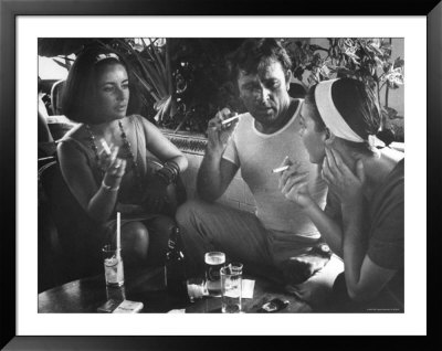 Elizabeth Taylor, Richard Burton And Ava Gardner Smoking Cigarettes In Cantina by Gjon Mili Pricing Limited Edition Print image