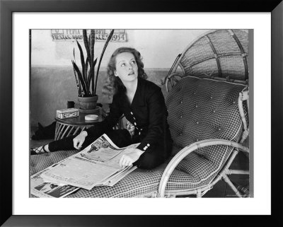 Actress Bette Davis Skimming Through The Morning Papers In Her Playroom At Home by Alfred Eisenstaedt Pricing Limited Edition Print image