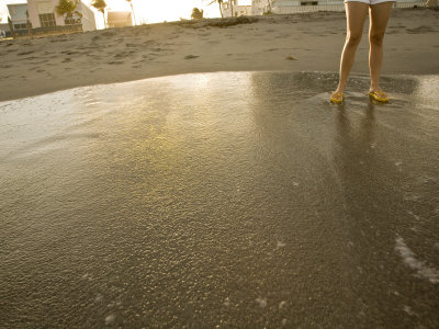 Girls Feet In Ocean, Top View by Images Monsoon Pricing Limited Edition Print image