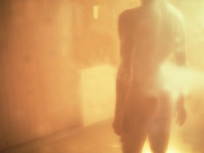 Standing Nude Male Figure In Golden Light, Rear View by Images Monsoon Pricing Limited Edition Print image