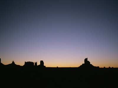 Sunrise Lights Up The Buttes And Mittens Of Monument Valley by Taylor S. Kennedy Pricing Limited Edition Print image