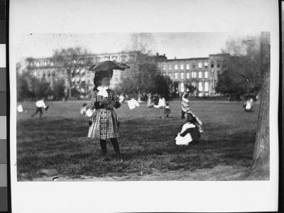 Mildred Grimwood, All Dressed Up And Carrying A Parasol, In A Park Surrounded By Children Playing by Wallace G. Levison Pricing Limited Edition Print image