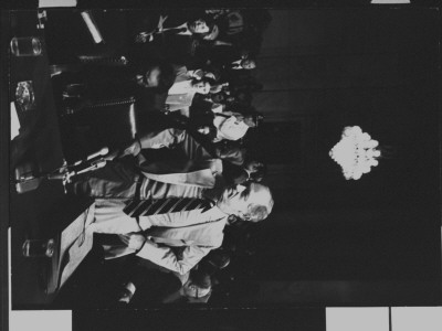 E. Howard Hunt Standing Behind Witness Table With Others Seated Behind Him; Watergate Hearings by Gjon Mili Pricing Limited Edition Print image