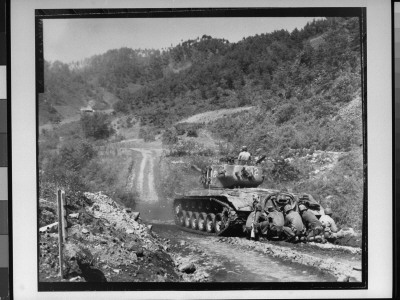 Marines Taking Cover Behind Tank While It Fires On Communist Troops On Front Lines, Korean War by Sgt. John Babyak Jr. Pricing Limited Edition Print image