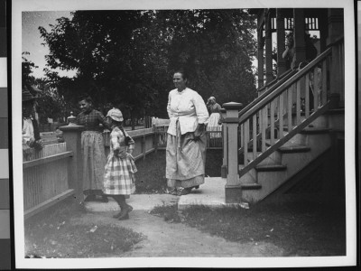 Two Women And A Girl Outside By The Front Entrance Of Their Home by Wallace G. Levison Pricing Limited Edition Print image