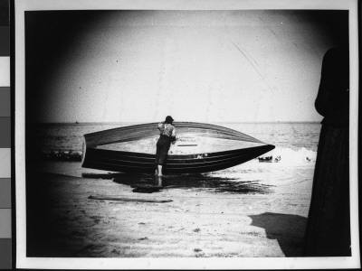 A Boy Draining And Washing A Fishing Row Boat by Wallace G. Levison Pricing Limited Edition Print image