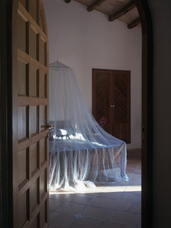 Son Vent Architect's Family Home In Mallorca Bedroom With Mosquito Net And Open Door by Richard Bryant Pricing Limited Edition Print image