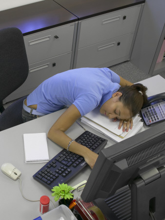 Office Life And Interiors, Young Woman Slumped On Desk by Richard Bryant Pricing Limited Edition Print image