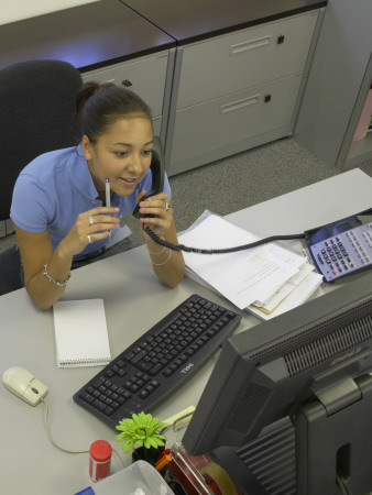 Office Life And Interiors, Young Woman On The Phone At Her Desk by Richard Bryant Pricing Limited Edition Print image