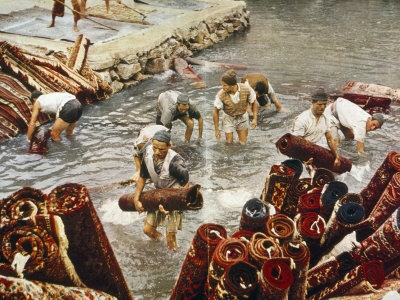 Men Give Rugs A Springtime Washing In An Outdoor Pool by Joseph Baylor Roberts Pricing Limited Edition Print image