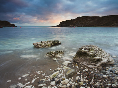 Sunset Over Circular Bay At Lulworth Cove In Dorset, England, Jurassic Coast World Heritage Site by Adam Burton Pricing Limited Edition Print image