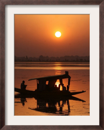 Shikara, Or Kashmiri Boat, In Dal Lake As The Sun Sets In Srinagar, India by Mukhtar Khan Pricing Limited Edition Print image