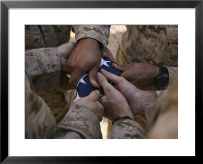 Marines Fold An American Flag After It Was Raised In Memory Of A Fallen Soldier by Stocktrek Images Pricing Limited Edition Print image