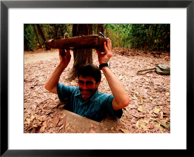 American Visitor Explores Tunnel At Former War Time Cu Chi Tunnel System, Ho Chi Minh, Vietnam by Stu Smucker Pricing Limited Edition Print image