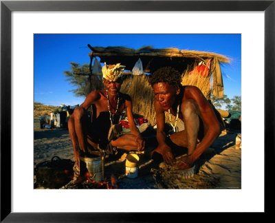 Kalahri Bushmen Cooking On Fire Outside Their Grass Homestead, South Africa by Ariadne Van Zandbergen Pricing Limited Edition Print image