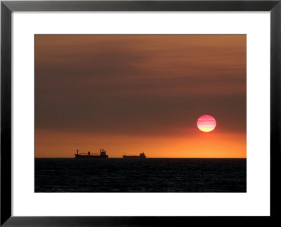 Cargo Ships Silhouetted On Horizon At Sunset, Cottesloe Beach by Orien Harvey Pricing Limited Edition Print image