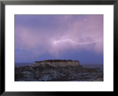 Lightning Strikes Above A Butte In Adobe Town In Wyoming's Red Desert by Joel Sartore Pricing Limited Edition Print image