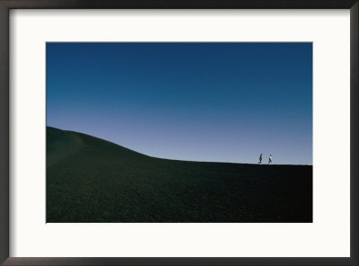 Tourists Walking Along A Lava Field In Craters Of The Moon National Park by Randy Olson Pricing Limited Edition Print image