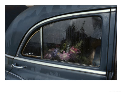 A Floral Arrangement Seen Through The Rain-Spattered Window Of A Car by Sam Abell Pricing Limited Edition Print image
