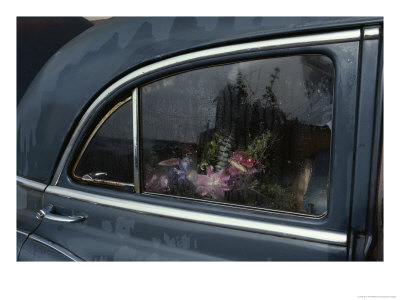 A Floral Arrangement Seen Through The Rain-Spattered Window Of A Car by Sam Abell Pricing Limited Edition Print image
