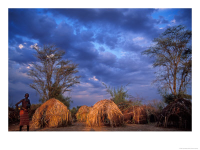 Mursi Huts Protect Tenants From The Oncoming Storm, Ethiopia by Janis Miglavs Pricing Limited Edition Print image
