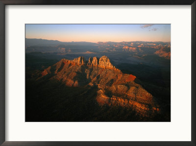 Low Sunlight Shines On Mountains Outside Of St. George, Utah; Zion National Park Is In The Distance by Melissa Farlow Pricing Limited Edition Print image