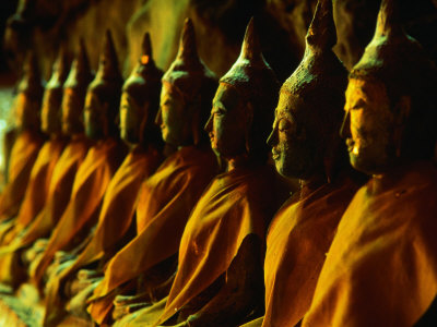 Nine Buddha Statues Sitting In Row In Khao Luang Caves, Phetburi, Phetchaburi, Thailand by Chris Mellor Pricing Limited Edition Print image
