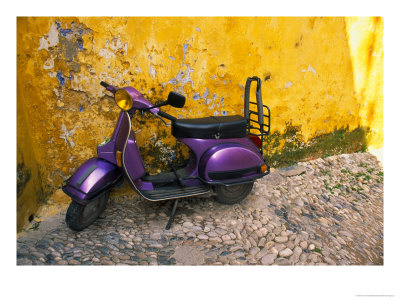 Vespa And Yellow Wall In Old Town, Rhodes, Greece by Tom Haseltine Pricing Limited Edition Print image